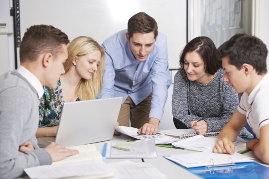 A group of high school students at a table working together