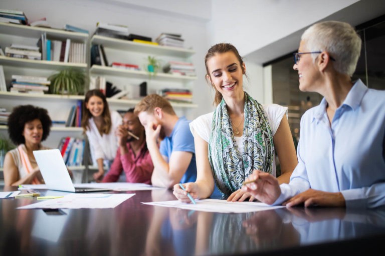 Professionals in a conference room have a discussion.