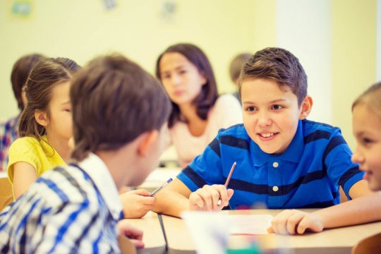 Group of kids collaborating together on an assignment