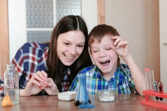 Mom and young son doing a science experiment at home.