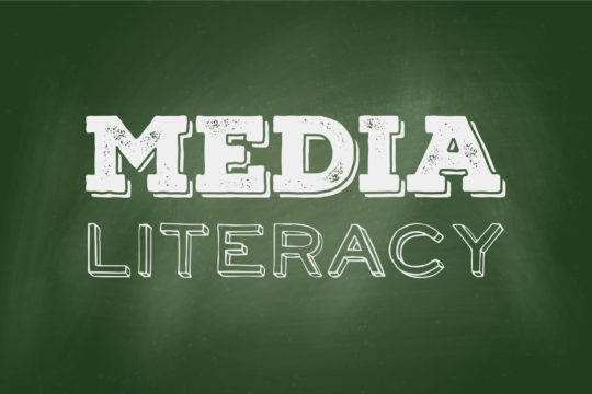 ‘Media Literacy’ drawn on a green chalkboard.