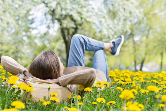 Woman laid back and relaxing in the grass