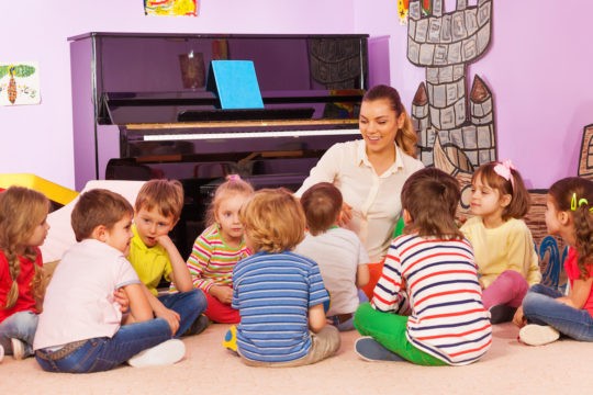 Female teacher telling a story to a group of students