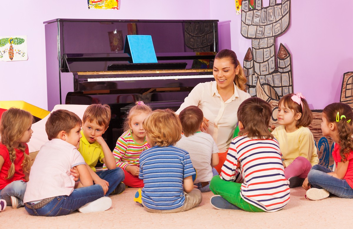 Female teacher telling a story to a group of students