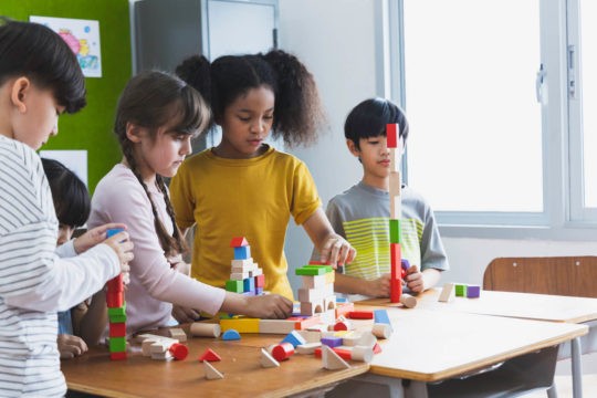 Group of young stuents working together on a project.