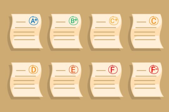 A collection of student tests with passing grades down to failing.