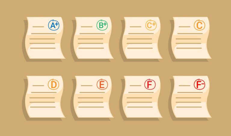 A collection of student tests with passing grades down to failing.