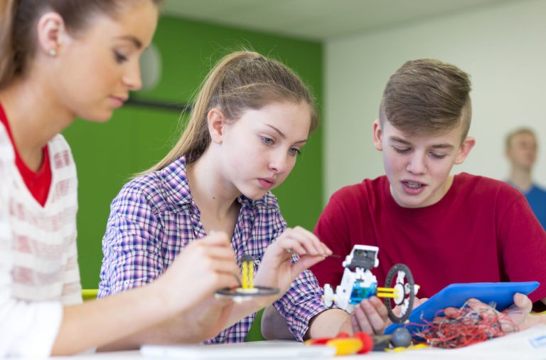 Group of students working together on a robot project.