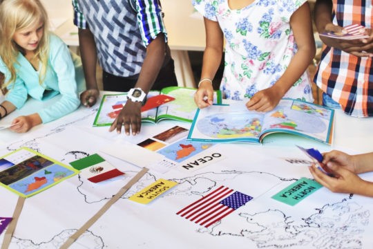 Group of young students working on a project together.