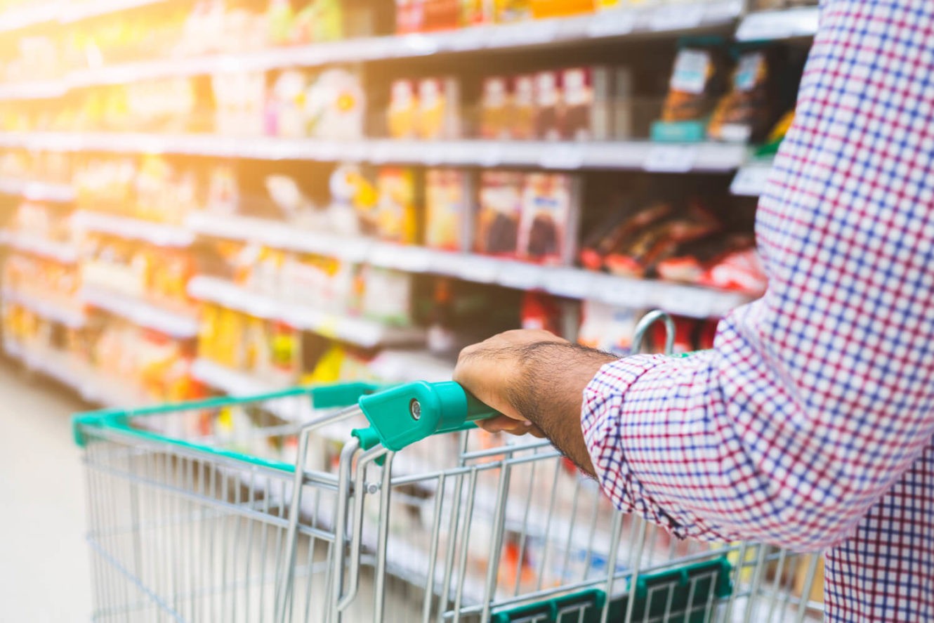 Man pushing shopping cart at grocery store